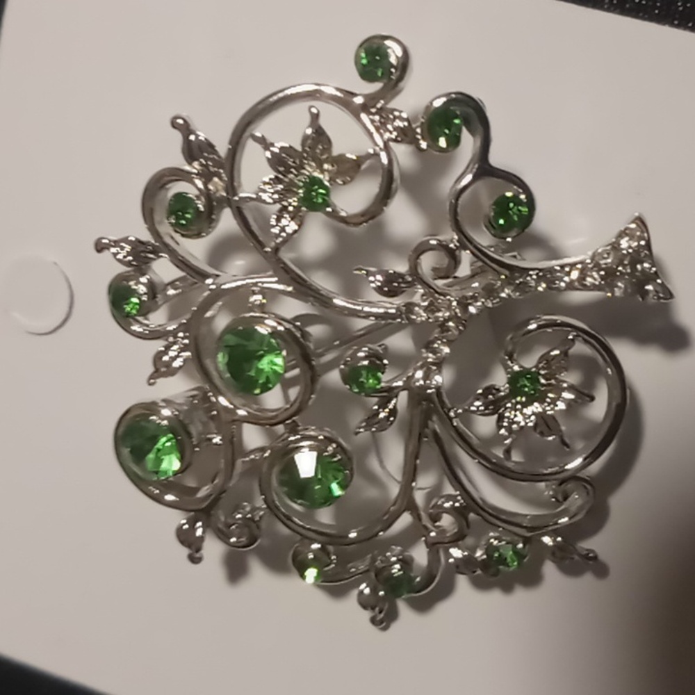 Tree of life with green stones and a rhinestone trunk .